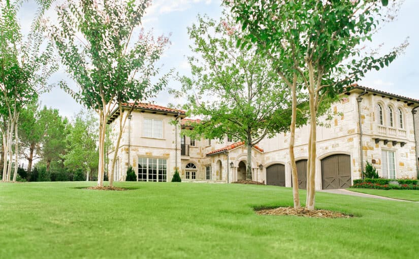 Spanish style house with lawn with green grass and trees